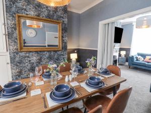 a dining room with a table with chairs and a mirror at 3 Auborough Street in Scarborough +20 photos