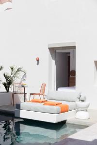 a bedroom with two beds next to a swimming pool at Viva Nove Suites in Kamari