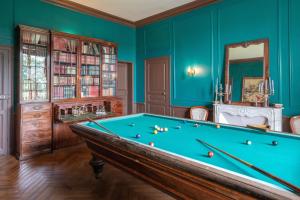 a pool table in a room with blue walls at Château de la Tourlandry in Chemillé