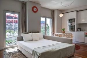a bedroom with a large bed and a large window at Ola Lisbon - Benfica in Lisbon