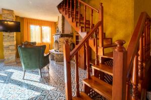 a living room with a staircase and a green chair at Sea Smelling Boutique Hotel in Kemer
