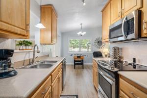 a kitchen with wooden cabinets and a sink at Sweet Haven - Home with EV Charger near Yosemite in Groveland