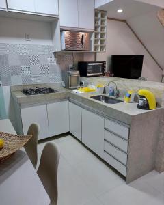 a kitchen with a sink and a counter top at Villa dos Diamantes - 14 in Porto Seguro