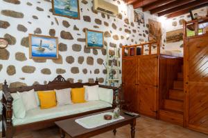 a living room with a couch and a bunk bed at Vintage White House Patmos in Patmos