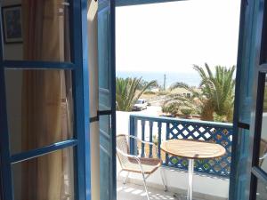 a balcony with a table and chair and the ocean at Sea Melody in Lefkos Karpathou