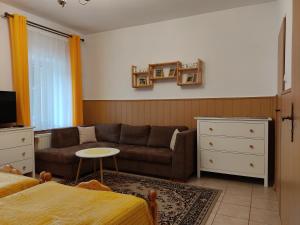 a living room with a couch and a bed at MAGNOLIA Duszniki Zdrój in Duszniki Zdrój