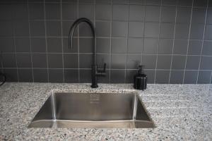 a kitchen sink with a faucet on a counter at Ba & Bu Apartment 1 in Katerini