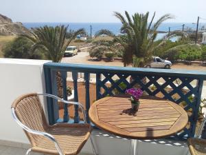 a table and chairs on a balcony with the ocean at Sea Melody in Lefkos Karpathou