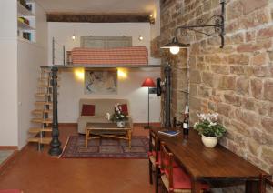 a living room with a brick wall and a loft bed at Florence Rental in Florence