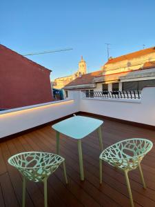 a table and two chairs on a balcony at AIRVA: Apartamentos Bajada de la Libertad in Valladolid