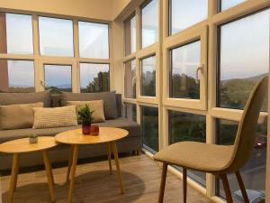 a living room with a couch and a table and chairs at Mirabilis Apartments in Međugorje