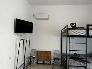 a room with two bunk beds and a flat screen tv at Zeus in Cluj-Napoca