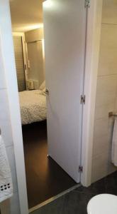 a bathroom with a door leading to a bedroom at Ático,loft ,duplex in Madrid