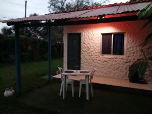 a table and chairs in front of a house at Portón Azul in Montañita +25 photos