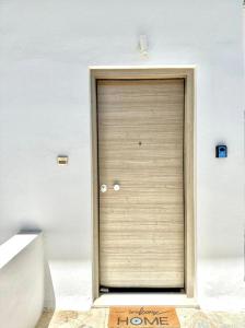 a door in a wall with a sign in front of it at The Aegean Nest in Athens