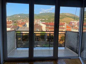 a view from an open window of a building at Blerta's apartment in Prizren