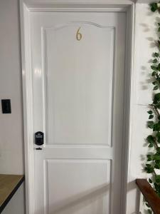 a white door with a silver handle on a wall at Suits Mirador de Luz in Cuenca