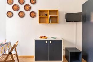 a room with a black cabinet and plates on the wall at Val di Luce Foemina RB in Abetone