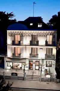 a large white building with lights on it at Hôtel Lutétia & Spa in La Baule