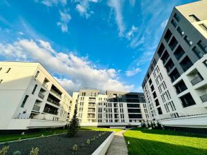 a group of buildings with a blue sky in the background at Modern Apartment in Timisoara in Timişoara