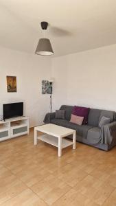 a living room with a couch and a coffee table at Casita Blum in La Asomada