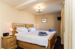 a bedroom with a bed with towels on it at Wixey House in Chipping Campden