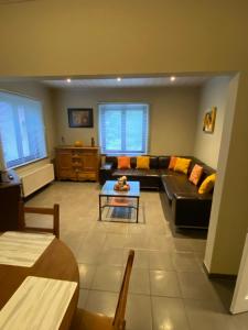 a living room with a couch and a table at Chez Mo in La-Roche-en-Ardenne