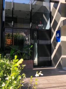 a black door of a building with a sign on it at Distrito A FMA-Coliving in Salta