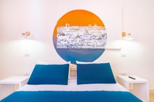 - un lit avec 2 oreillers bleus dans l'établissement Sunscape Rooms Cagliari City Center, à Cagliari