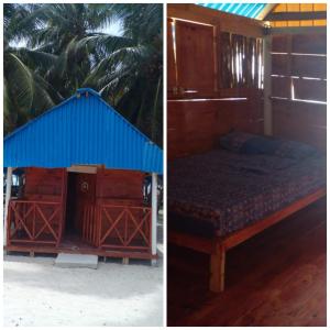 a bed in a wooden house with a blue roof at Diegun Tours in Panama City
