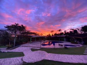 a sunset over a patio in a yard at Ecohotel La Casona Pereira in Pereira