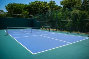 a tennis court with a net on top of it at Platinum Yucatan Princess Adults Only - All Inclusive in Playa del Carmen