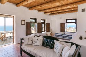 a living room with a couch and a view of the ocean at Villa Unica in Yiannioú