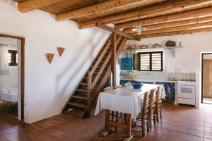 a kitchen with a staircase and a table with chairs at Villa Unica in Yiannioú