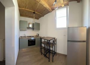 a kitchen with a stainless steel refrigerator and a table at Airam Room’s in Capurso