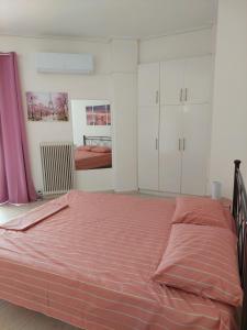 a bedroom with a large bed with a red blanket at PlazaVerrosA6Room in Tripoli
