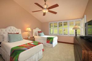 a bedroom with two beds and a ceiling fan at WAILEA ELUA, #1508 condo in Wailea
