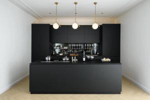 a black kitchen with a bar in a room at Georgetown Luxury Heritage House 4BR 10Pax in George Town