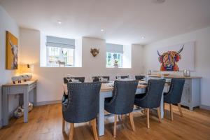 a dining room with a table and chairs at Vine Cottage in Halford