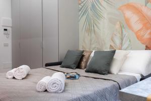 a bedroom with a bed with towels on it at Exotic House in central of Milan in Milan