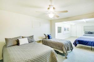a bedroom with two beds and a ceiling fan at Main Street Townhome - 12 Miles to Bear Lake! in Paris