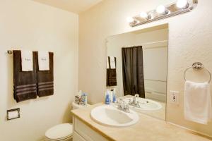 a bathroom with a sink and a toilet and a mirror at Main Street Townhome - 12 Miles to Bear Lake! in Paris +21 photos