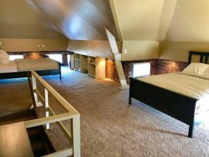 a large room with two beds and a staircase at Frankfort 1 (V2) in Columbus