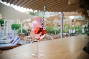 a drink with a straw in a glass on a table at Odysseia Hotel Kapetanios in Limassol