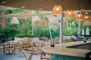 a restaurant with tables and chairs and lights at Odysseia Hotel Kapetanios in Limassol
