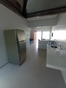 a kitchen with a stainless steel refrigerator in a room at Residência em Bairro Nobre in Imperatriz