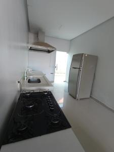 a kitchen with a stove and a refrigerator at Residência em Bairro Nobre in Imperatriz