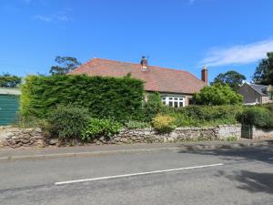 a house on the side of a road at Charlies Cottage in Duns