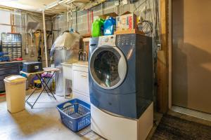 a washing machine in a room with a kitchen at Cozy Hiwassee Vacation Rental with Yard in Hiwassee