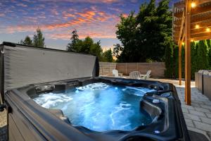 a jacuzzi tub in a backyard at sunset at Beautiful, Historic Home, heart of McMinnville. in McMinnville